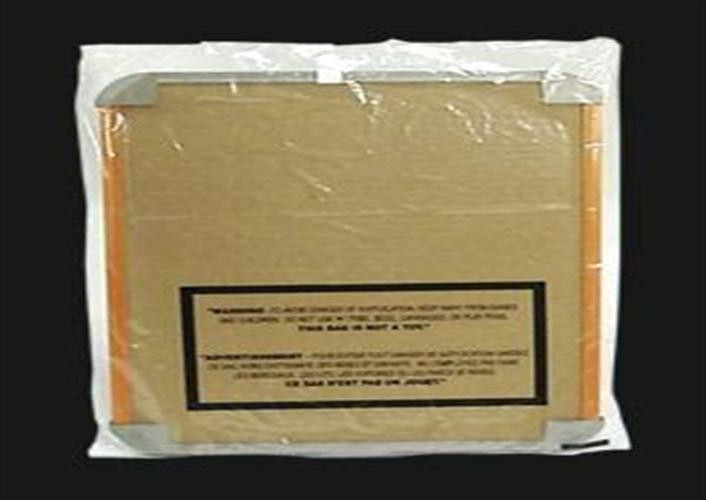 A square, cardboard-backed item wrapped in clear plastic with protective corner covers and a warning label printed on the back.