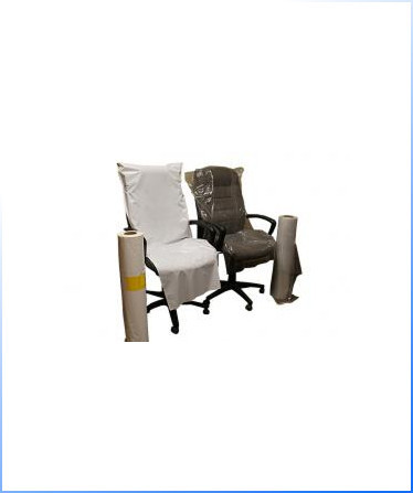 Two office chairs, one covered with a white sheet and the other with clear plastic, sit side by side; two rolls of covering material are placed next to each chair.