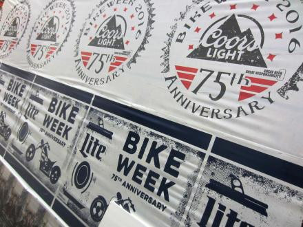 Posters promoting the 75th anniversary of Bike Week feature Coors Light and Miller Lite logos with motorcycle-themed graphics.