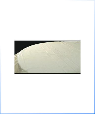 A close-up view of a plain white table covered with a white tablecloth against a dark background.